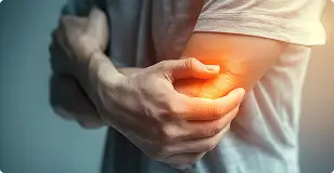 A close-up view of a person holding their elbow, representing the minimally invasive Elbow Artery Embolization (EAE) for chronic tennis elbow.